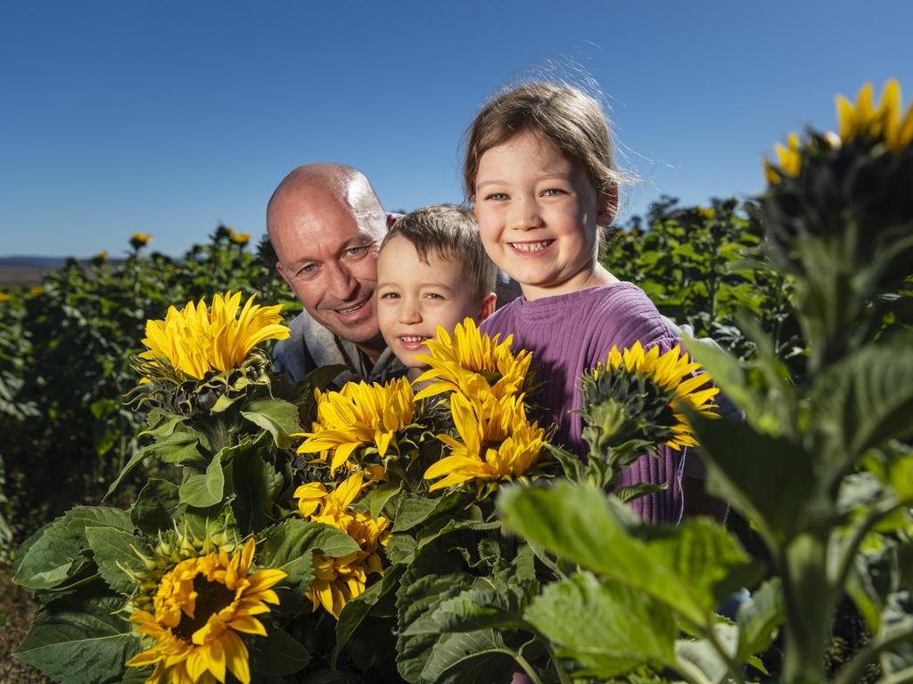 Jon Gilmore with kids Caden and Alaina Gilmore at Warraba Sunflowers, Saturday, June 22, 2024. Picture: Kevin Farmer