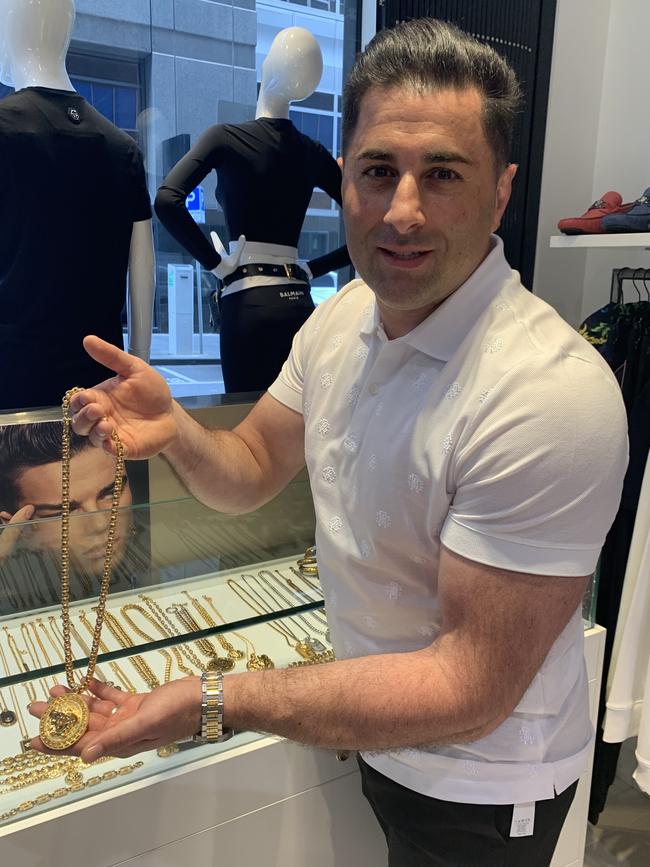 Disappointed Le Style shop owner Steven Adigrati models the type of Versace necklace which was stolen in the elaborate fishing rod heist. Picture: Herald Sun