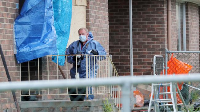 Police investigators at the scene of the home where Michelle Meades’ body was found.