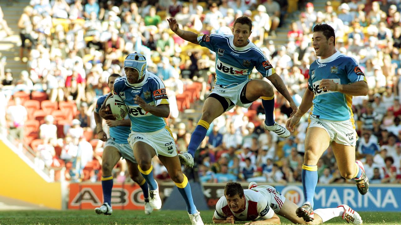 NRL. Titans versus Dragons. Titans Preston Campbell (ball), Scott Prince and Mark Minichiello.