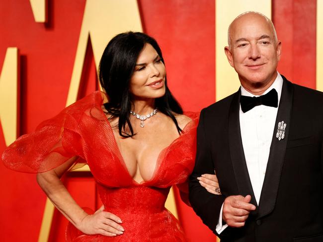 Executive chairman of Amazon Jeff Bezos and girlfriend US actress Lauren Sanchez attend the Vanity Fair Oscars Party at the Wallis Annenberg Center for the Performing Arts in Beverly Hills, California, on March 10, 2024. (Photo by Michael TRAN / AFP)