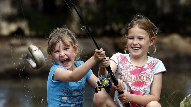 Jaimee and Courtney Dodson catch a rainbow trout. Picture: News Corp Australia