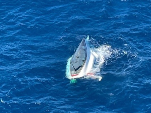 A RACQ LifeFlight Rescue helicopter crew has rescued a father and son who were stranded on an overturned yacht near Bundaberg on June 16, 2024. Picture: LifeFlight