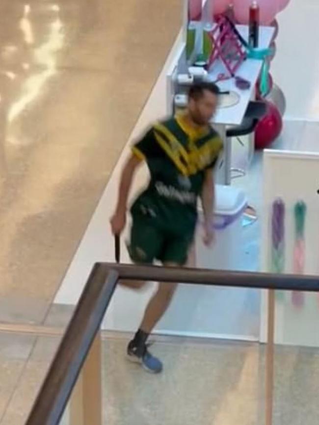 The knifeman jogs through the centre during the attack.