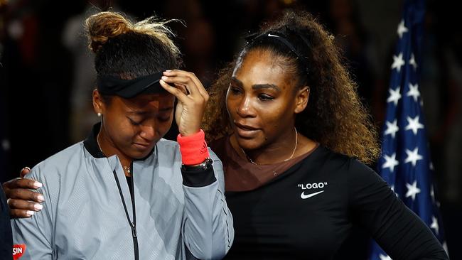 Serena Williams puts an arm around Naomi Osaka at the trophy ceremony.