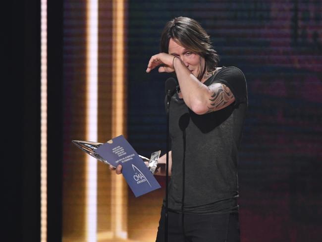 Keith Urban wipes away tears as he accepts the award for entertainer of the year. Picture:  Charles Sykes/Invision/AP.