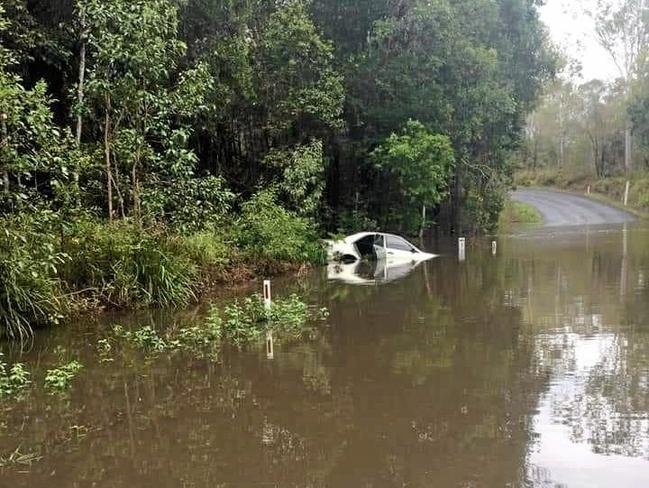 ROAD CLOSED: A car tried to cross the flooded Farnsfield Rd near Childers overnight. Picture: Contributed