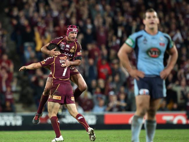 Cooper Cronk and Johnathan Thurston celebrate Queensland’s last-ditch field goal to win game three in 2012. Picture: Darren England