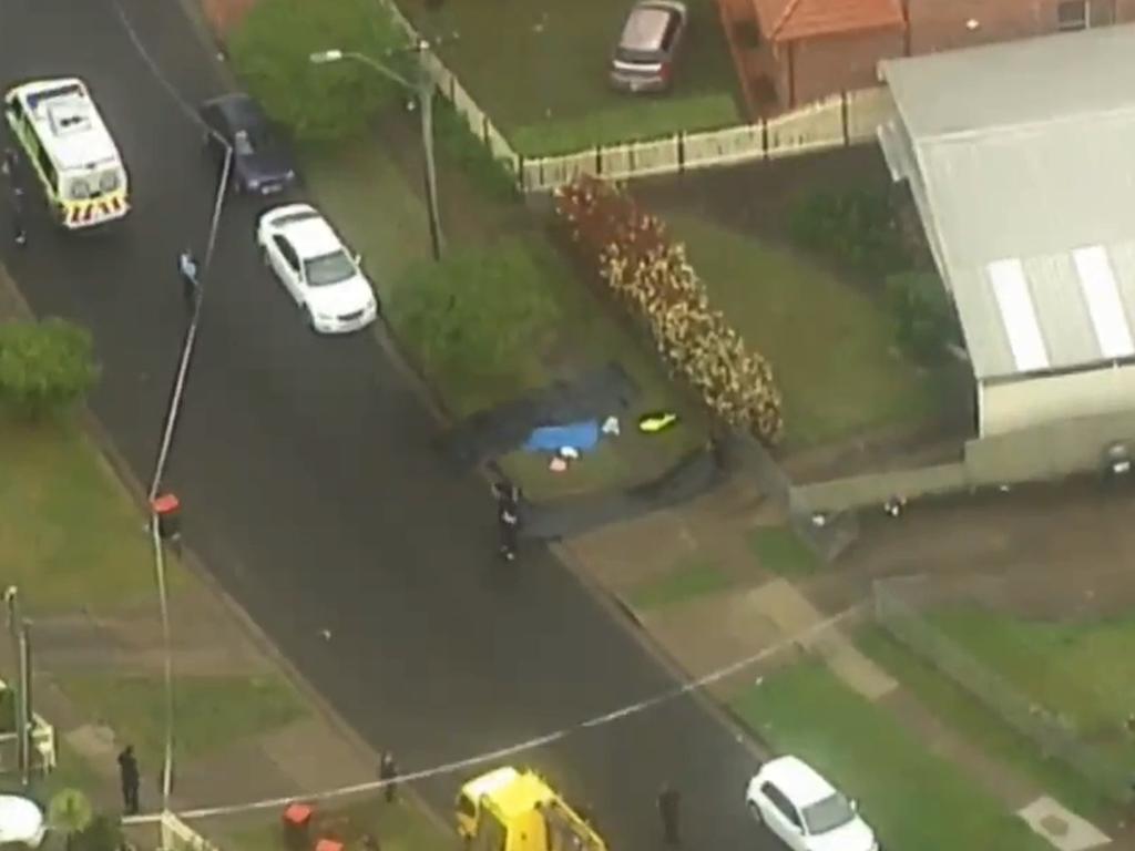 The victim’s body lay under a blue tarp on a Blacktown property. Picture: 7 News