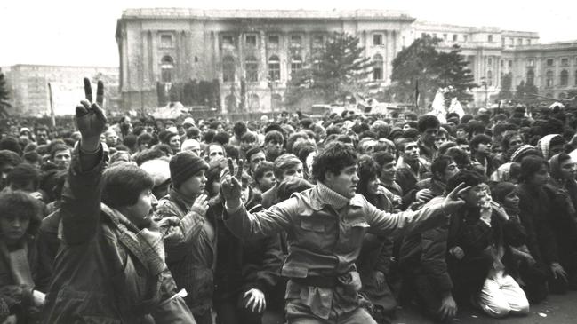 TA large crowd of people outside the Communist Party Central Committee building in Bucharest observe a moment of silence for those murdered by Ceausescu's Securitate. Picture: Hedley Thomas