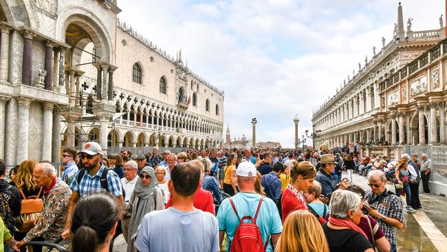 The visible effects of overtourism at the Doge's Palace in Piazza San Marco on a busy day in Venice, Italy