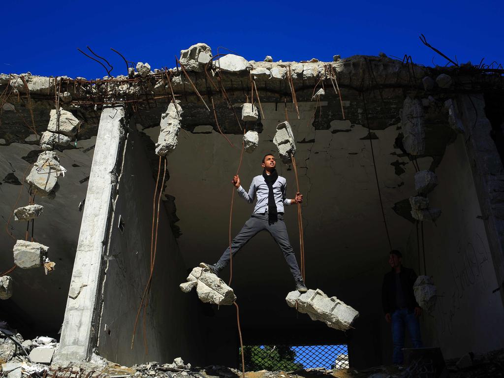 Palestinians play in the ruins of a building that was destroyed in the 2014 war between Israel and Hamas militants, in Gaza City, on February 16, 2016. Picture: AFP / MOHAMMED ABED