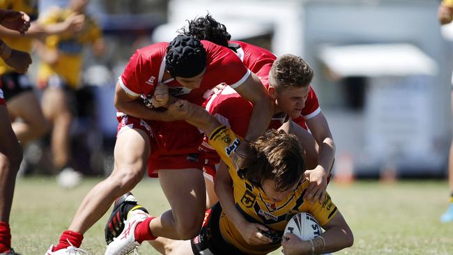 05/03/2023 - Wide Bay Bulls players team up for a tackle on a Sunshine Coast Falcons opponent in the Mal Meninga Cup. Picture: Josh Woning QRL