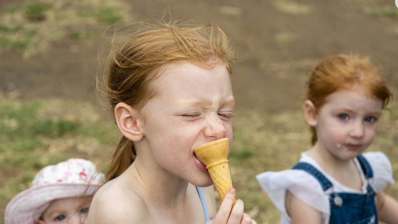 Macee Lloyd enjoys her ice cream with her sisters at the 2022 Toowoomba Royal Show, Friday, March 25, 2022. Picture: Kevin Farmer