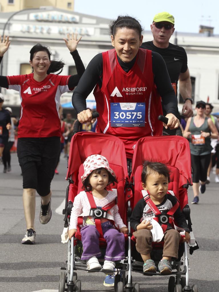 CITY to BAY - FINISH LINE. Yoshi Yoshizaki of Pooraka with his 2 year old twins, Chia and Yuma, and wife Chi on Yoshi's right. 15 September 2019. (AAP Image/Dean Martin)