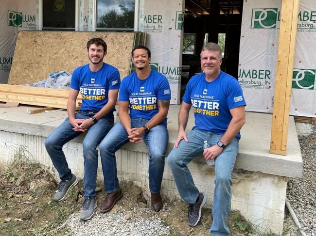 This photo taken in September 2022 shows Louisville mass shooter Connor Sturgeon (left) smiling while doing volunteer work. The man on the far right is his colleague Troy Haste.