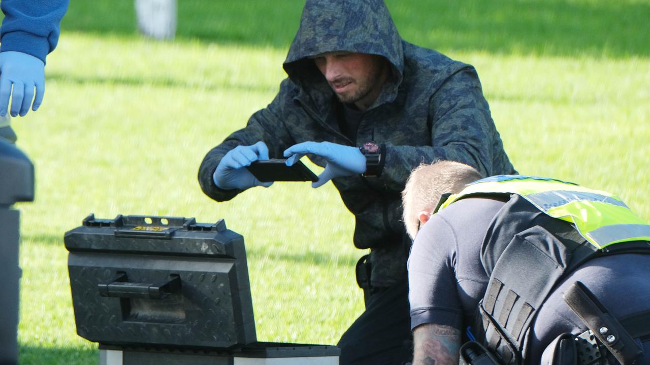 Police seize items from a car in Rippleside. Picture: Mark Wilson