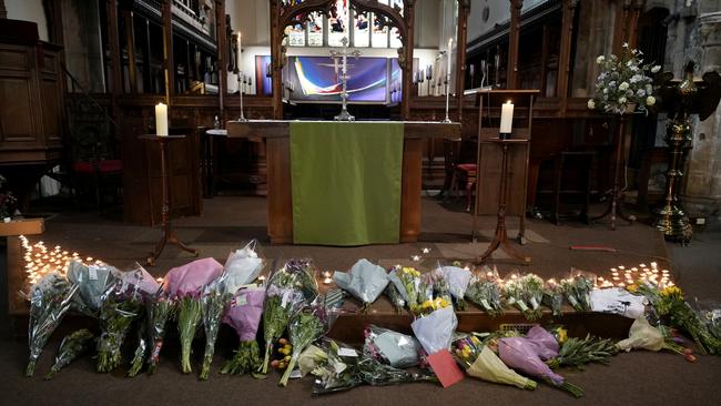 Flowers and candles lie at the altar after being placed by friends of the deceased during a vigil at St Peter’s Church in Nottingham, England. Picture: Christopher Furlong/Getty Images