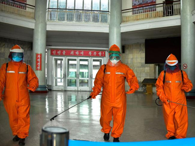 Railway station staff disinfecting Pyongyang station premises as a prevention measure against the coronavirus. Picture: AFP/KCNA via KNS