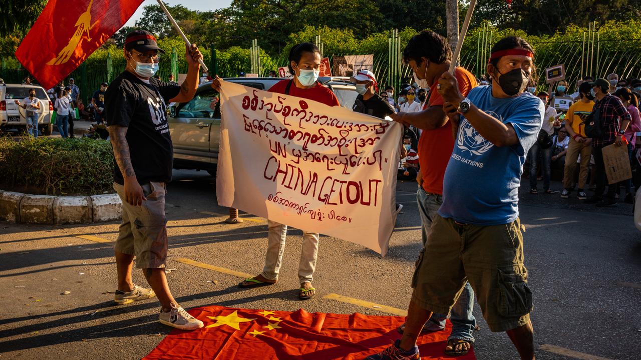 Protesters deface China's national flag in front of the United Nations Development Program (UNDP) office on February 11 in Yangon, Myanmar. Hkun Lat/Getty Images