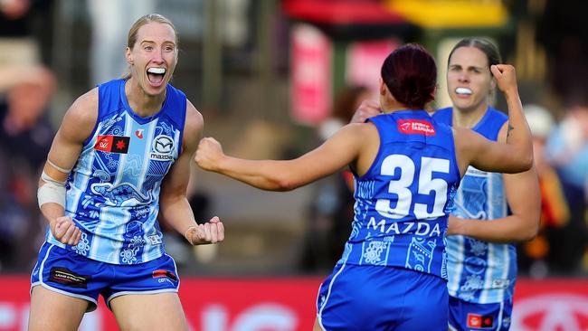 ADELAIDE, AUSTRALIA - OCTOBER 25:Kate Shierlaw of the Kangaroos .celebrates a goal with Jenna Bruton during the 2024 AFLW Round 09 match between Kuwarna (Adelaide Crows) and the North Melbourne Tasmanian Kangaroos at Norwood Oval on October 25, 2024 in Adelaide, Australia. (Photo by Sarah Reed/AFL Photos via Getty Images)