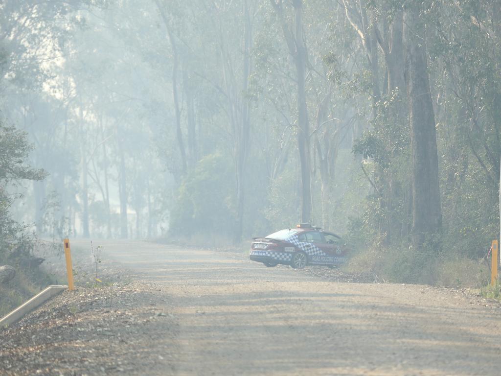 Road closure near Baffle Creek, which is in the firing line as the fires advance in a southewesterly direction. Picture: Mark Cranitch.