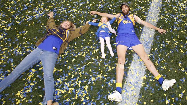 West Coast forward Josh Kennedy makes snow angles with his wife Emmi and daughter. Picture: David Caird