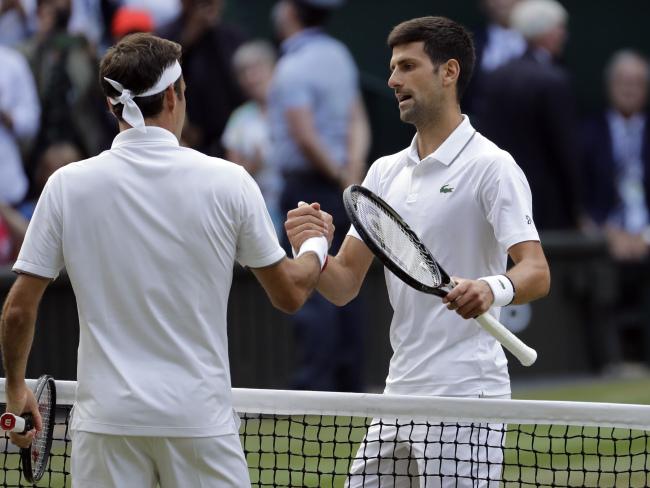 Roger Federer (L) and Novak Djokovic congratulate each other.