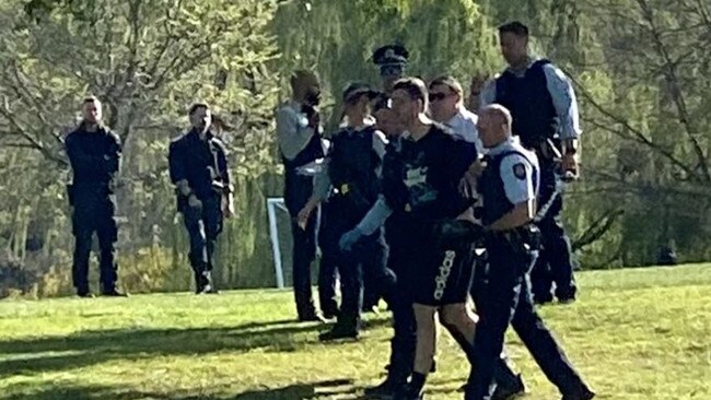 A man being taken into custody at the Australian National University in Canberra on September 18, 2023. Picture: 9 News