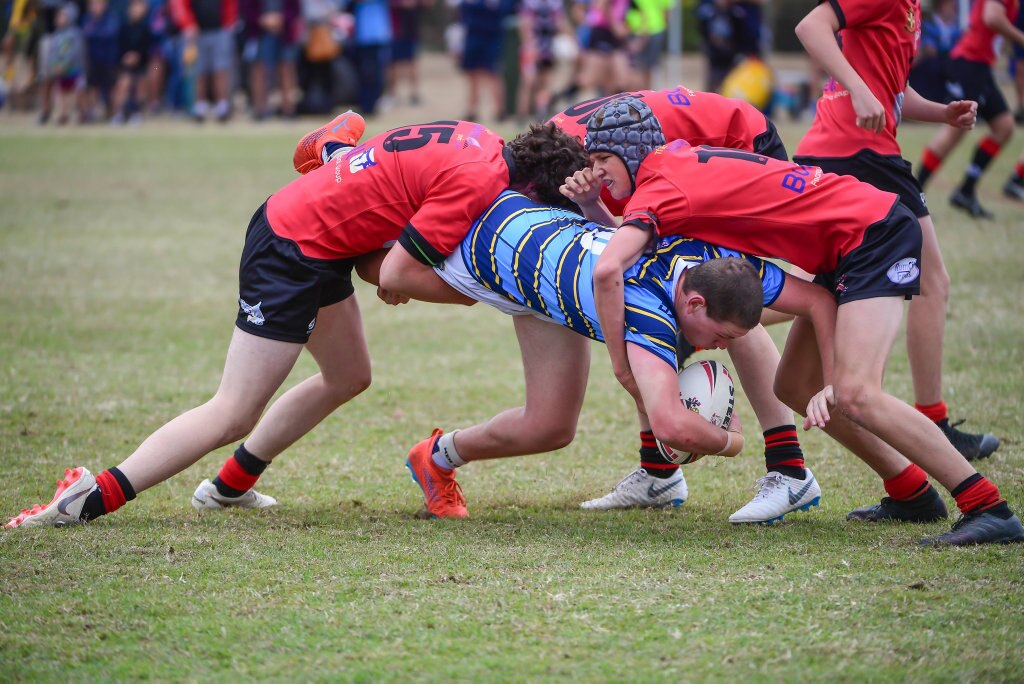 Jarvis Dean - St Columban's College, Caboolture gets tackled by Mack Druce, Alex Druce and Caileb Dimes Shalom College, Bundaberg