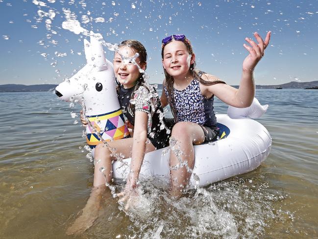 Sisters Chloe, 9, and April King, 11, of Sandy Bay, cool off at Long Beach. Picture: ZAK SIMMONDS