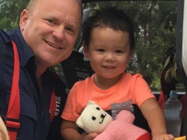 Captain David Richards of Riverstone Fire &amp; Rescue crew with Bodhi after the rescue.