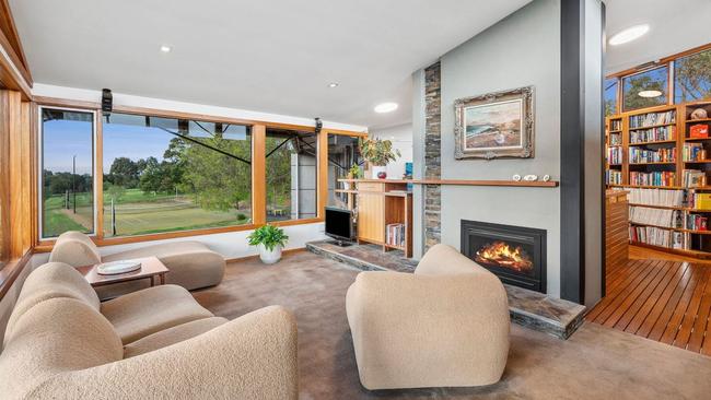 The first floor living room overlooks the tennis court.