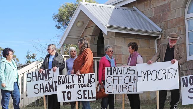 Protesters at St Martin’s Church in Dunalley, protesting that the Anglican Church has deconsecrated the church with little warning. Picture: LUKE BOWDEN