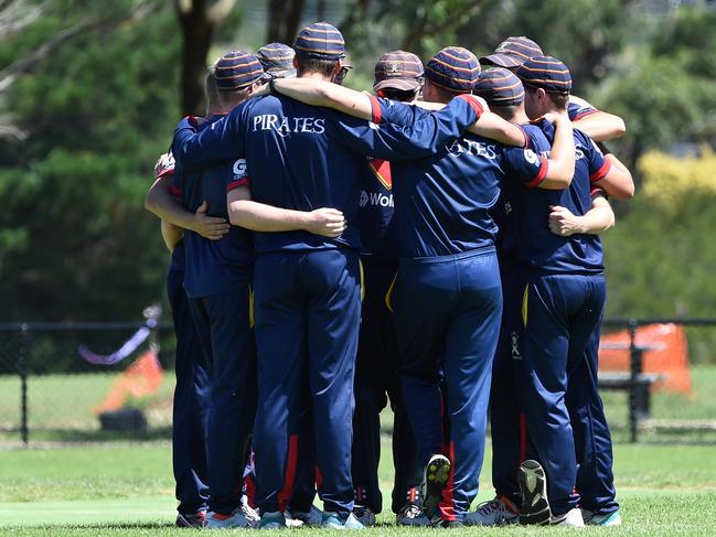 Peninsula Old Boys huddle after claiming wicket last season.