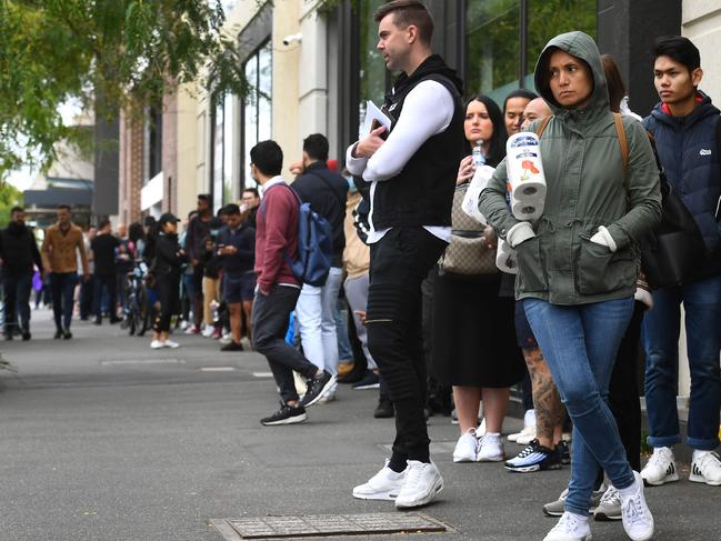 Hundreds of people queue outside an Australian government welfare centre, Centrelink, in Melbourne. Picture: AFP