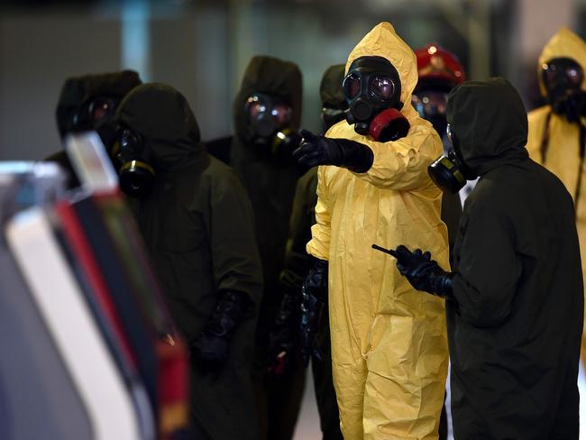 Members of Malaysia's Hazmat team conduct a decontamination operation at the departures terminal of Kuala Lumpur International Airport after police told the public they would do everything possible to ensure there was no risk from the lethal VX nerve agent used to assassinate Kim Jong-Nam. Picture: AFP