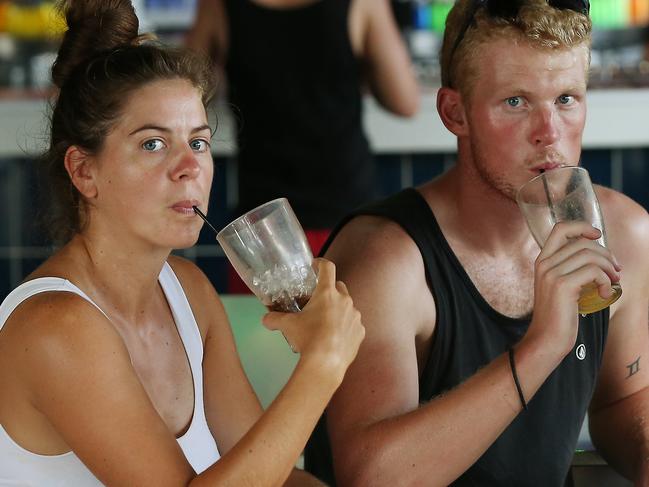 The Queensland Government's controversial lockout laws for licensed premises have been passed through parliament, meaning pubs and clubs in Cairns will be forced to lock out patrons at 1am. (L-R) Backpackers Astrid Wijnen, 28, of the Netherlands, Christian Houghton, 25, of England and Kirstie Price, 22, of England have a drink at the outdoor bar of Gilligan's backpacker resort and nightclub. PICTURE: BRENDAN RADKE