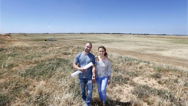 Anna and Artur Stanislawski look at plans on the site they are buying in Eden Village in Two Wells. Picture: Supplied