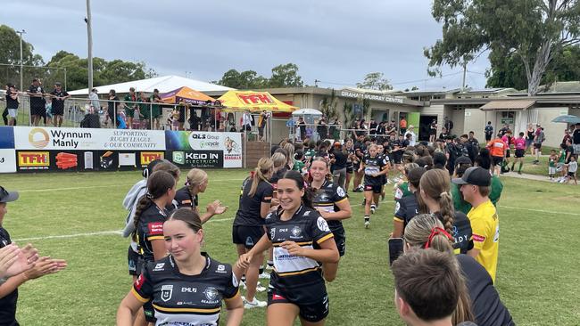 The Tweed Seagulls 19s run onto the field.