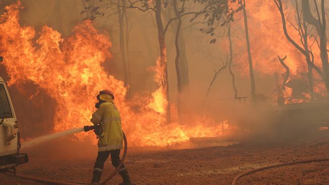 Firefighters at Wooroloo on Tuesday helping to battle an 80km-long, out-of-control firefront. Picture: Evan Collis