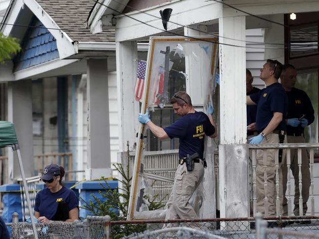 In this May 7, 2013 file photo, members of the FBI evidence response team carry out the front screen door from the Cleveland home of Ariel Castro, where three women escaped after 10 years of captivity. Picture: AP Photo/Tony Dejak, File