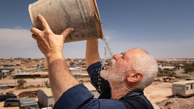 Russell Marks, 59, of the opal mining town of Andamooka cools down as temperatures rise above 40 degrees again. PICTURE: Brad Fleet