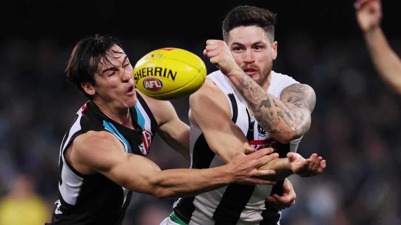 Connor Rozee tackles Magpie Jack Crisp on Saturday night. Picture: James Elsby/AFL Photos