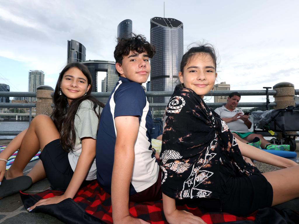 Crystal, 12, Jeremy, 14, and Natalie Kurek, 12, await the fireworks at South Bank. Picture: Steve Pohlner