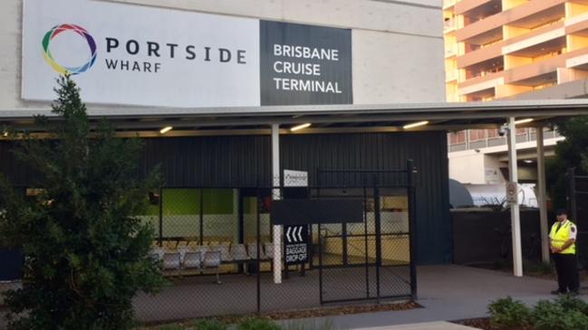 A guard outside the cruise terminal this morning. All passengers remained onboard the ship for about 45 minutes after docking.