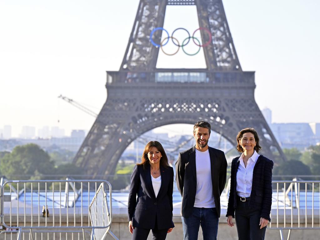Paris Mayor Anne Hidalgo, Paris 2024 President Tony Estanguet and Amelie Oudea-Castera, Minister for the Olympic and Paralympic Games, pose in front of the Eiffel Tower as the Olympic Rings are displayed. Picture: Getty