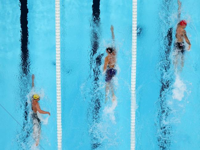 NANTERRE, FRANCE - JULY 30: (EDITORS NOTE: Image was captured using a robotic camera positioned above the field of play.) Elijah Winnington of Team Australia, Drew Kibler of Team United States and Matthew Richards of Team Great Britain compete in the Men's 4x200m Freestyle Relay Final on day four of the Olympic Games Paris 2024 at Paris La Defense Arena on July 30, 2024 in Nanterre, France. (Photo by Al Bello/Getty Images)