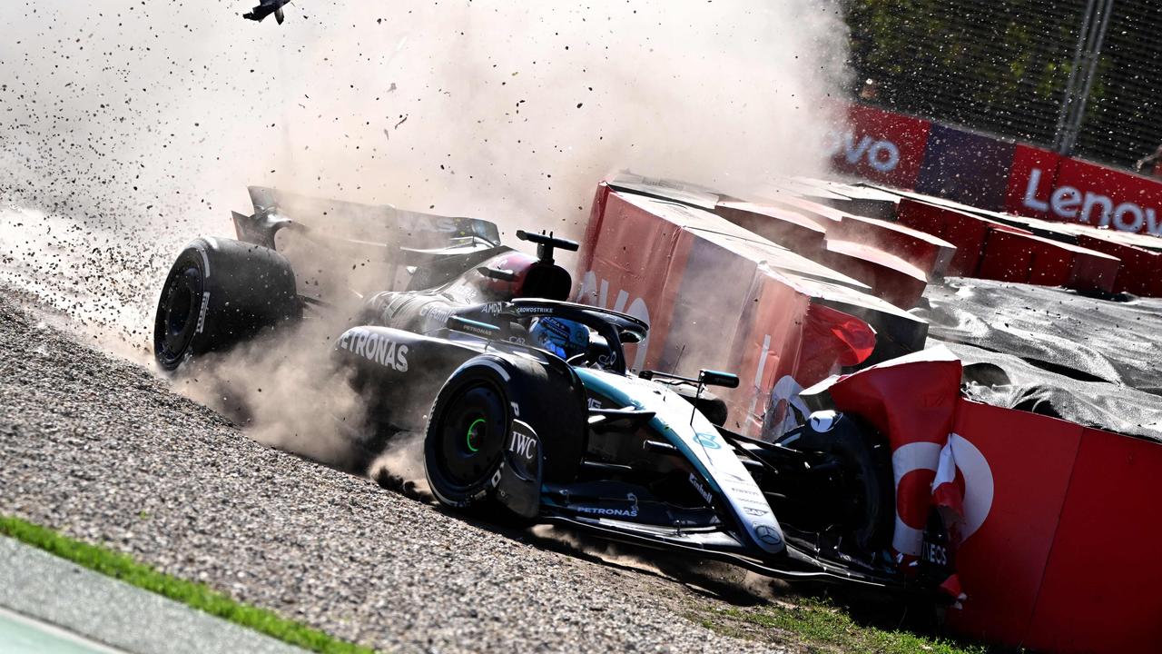 Mercedes' British driver George Russell skids through the gravels after a crash. (Photo by Paul Crock / AFP)