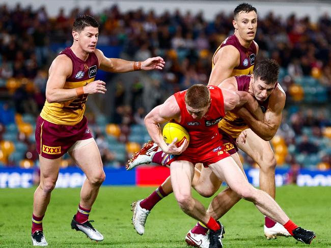 Josh Dunkley clamps Matt Rowell during the QClash.
